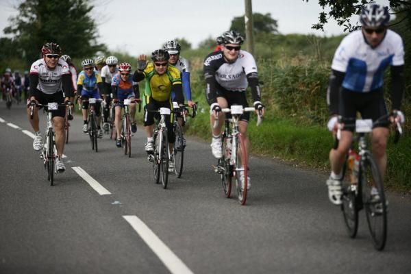 A wave from one rider as a pack of cyclists head off on The Prostate Cancer Charity ride in good spirits.