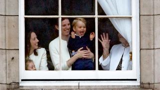 Prince George in the windows of Buckingham Palace