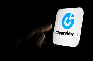 A finger about to press the Clearview AI App on a device