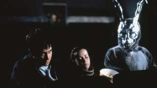 Jake Gyllenhaal sits in a theater with a demonic bunny in Donnie Darko