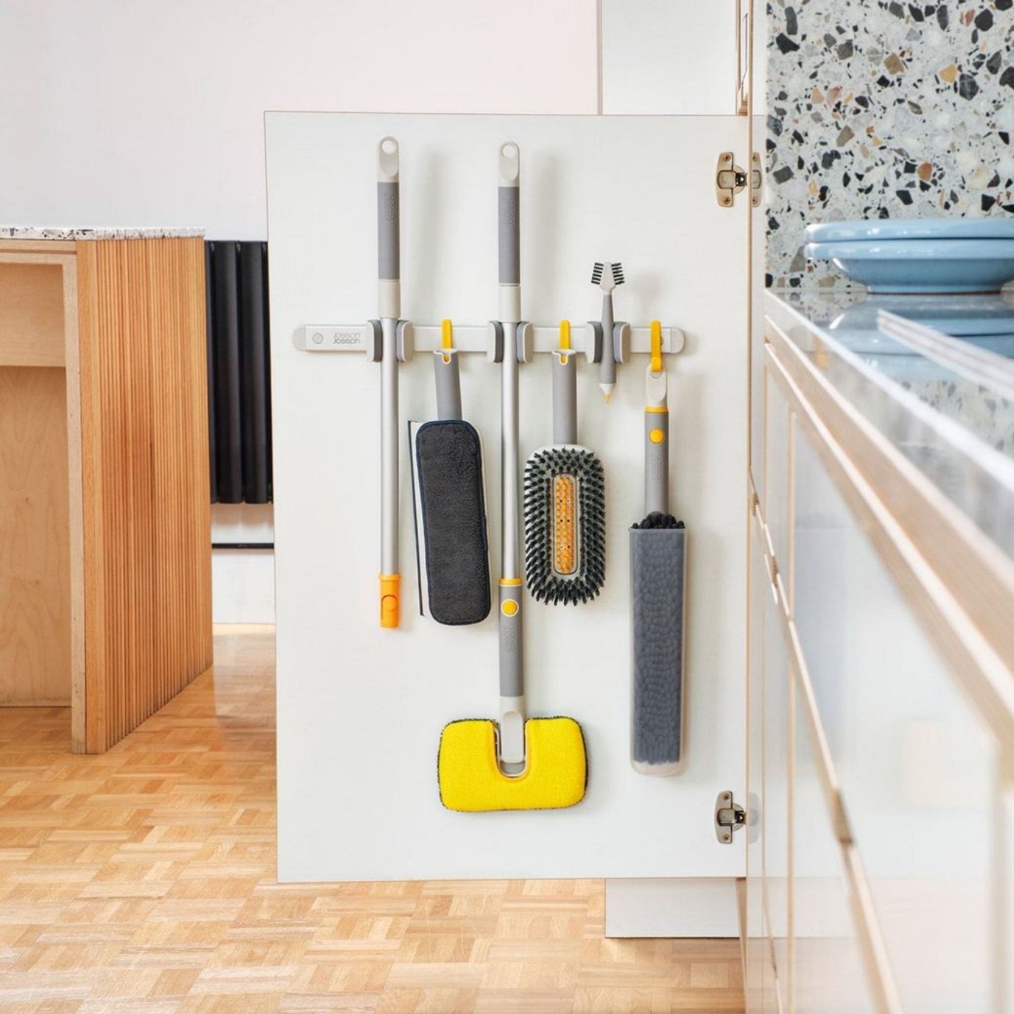 Joseph Joseph CleanTech set hanging from a kitchen cupboard