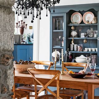 dining room with blue shelves and table with chairs