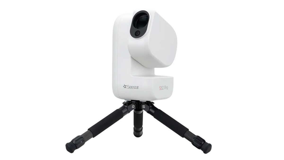The ZWO Seestar S50 Pro smart telescope pointing upwards on a small black tripod, against a white background.