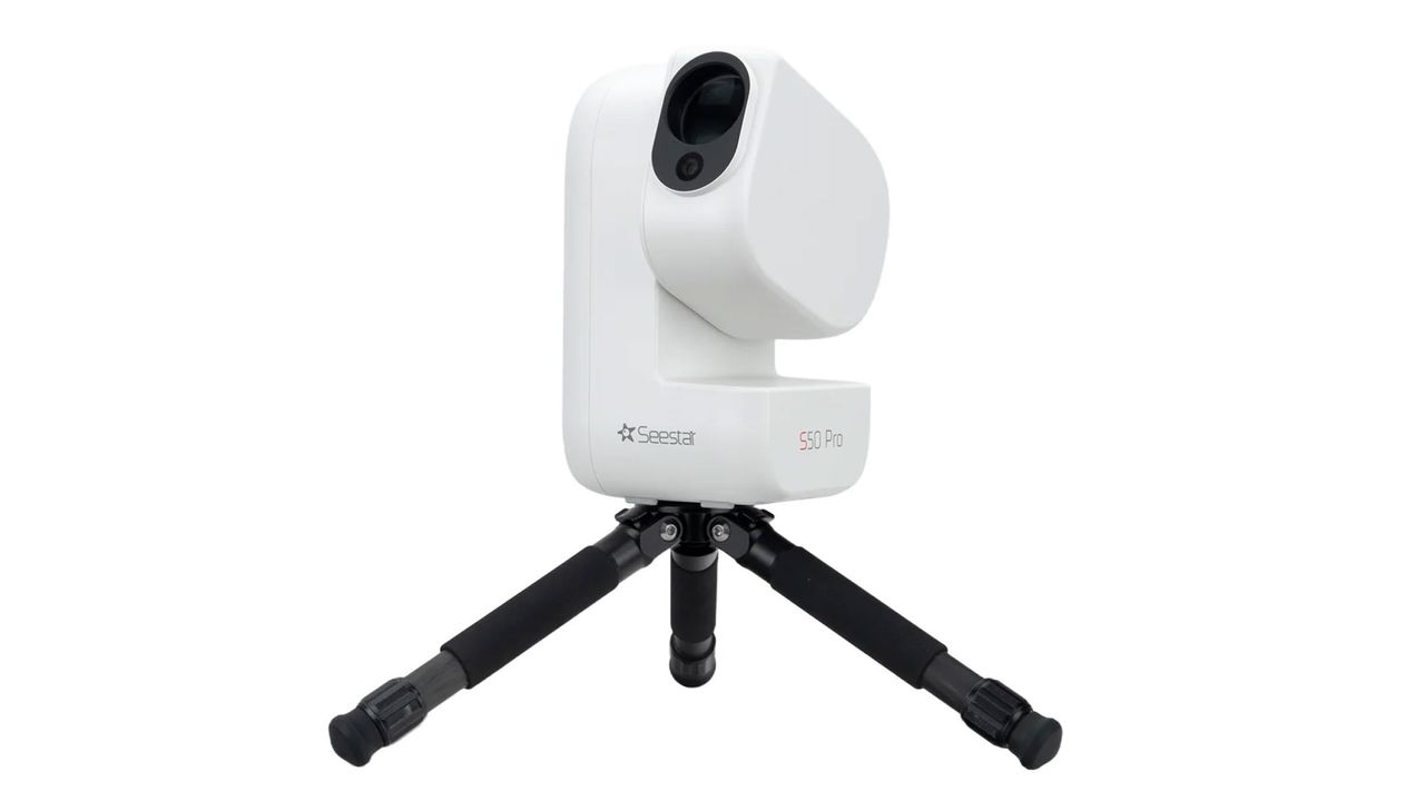 The ZWO Seestar S50 Pro smart telescope pointing upwards on a small black tripod, against a white background.