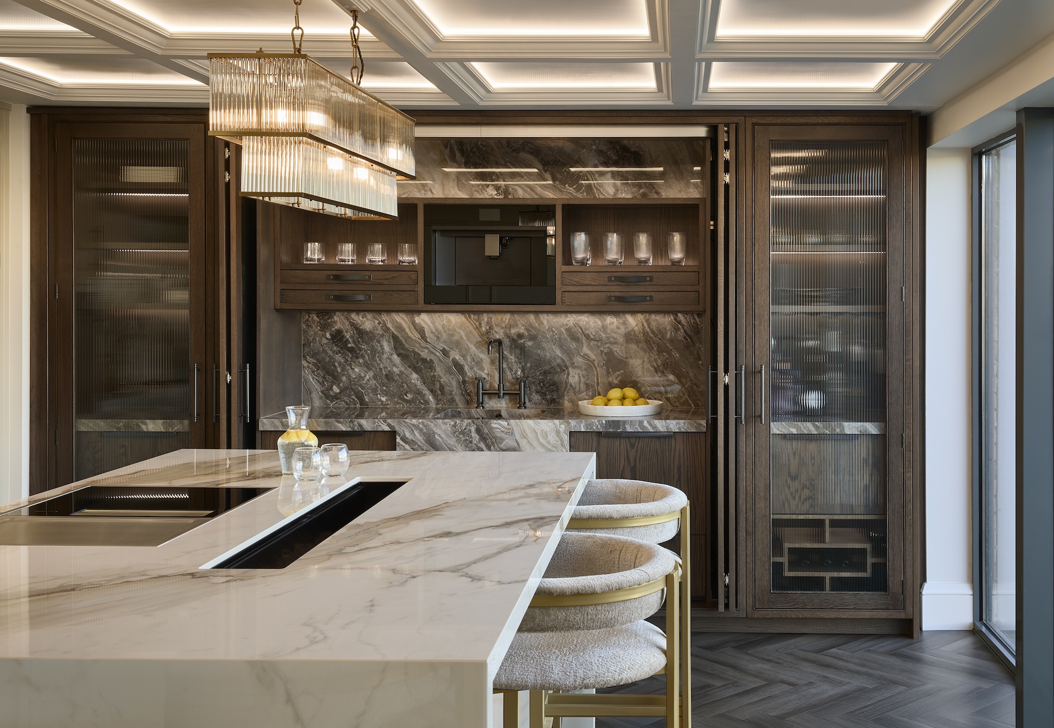 A contemporary twist on a dark wood English kitchen with reeded glass and hidden storage.