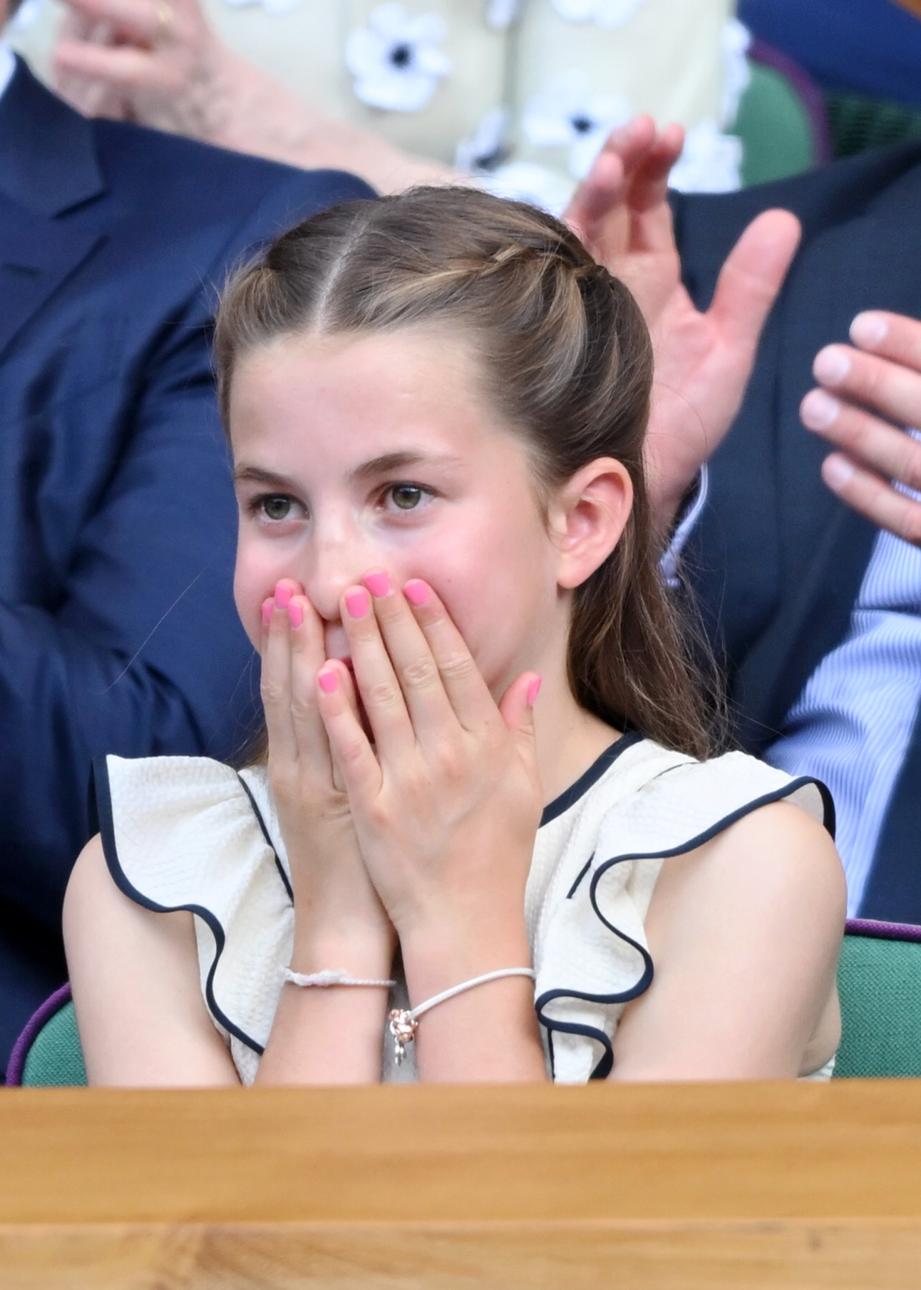 Princess Charlotte covering her mouth at Wimbledon