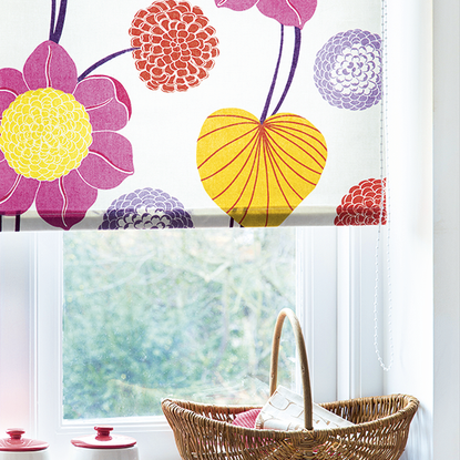 room with white window floral printed white curtain and wooden basket