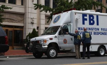 Local and federal investigators gather evidence after a security guard was shot in the arm at the headquarters of the Family Research Council on Wednesday in Washington, DC. Police are decidi