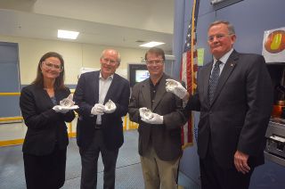 U.S. Mint director David Ryder with Ann (Collins) Starr, daughter of Apollo 11 command module pilot Michael Collins; Andy Aldrin, son of Apollo 11 lunar module pilot Buzz Aldrin; and Mark Armstrong, son of Apollo 11 commander Neil Armstrong, hold Apollo 11 50th anniversary coins.