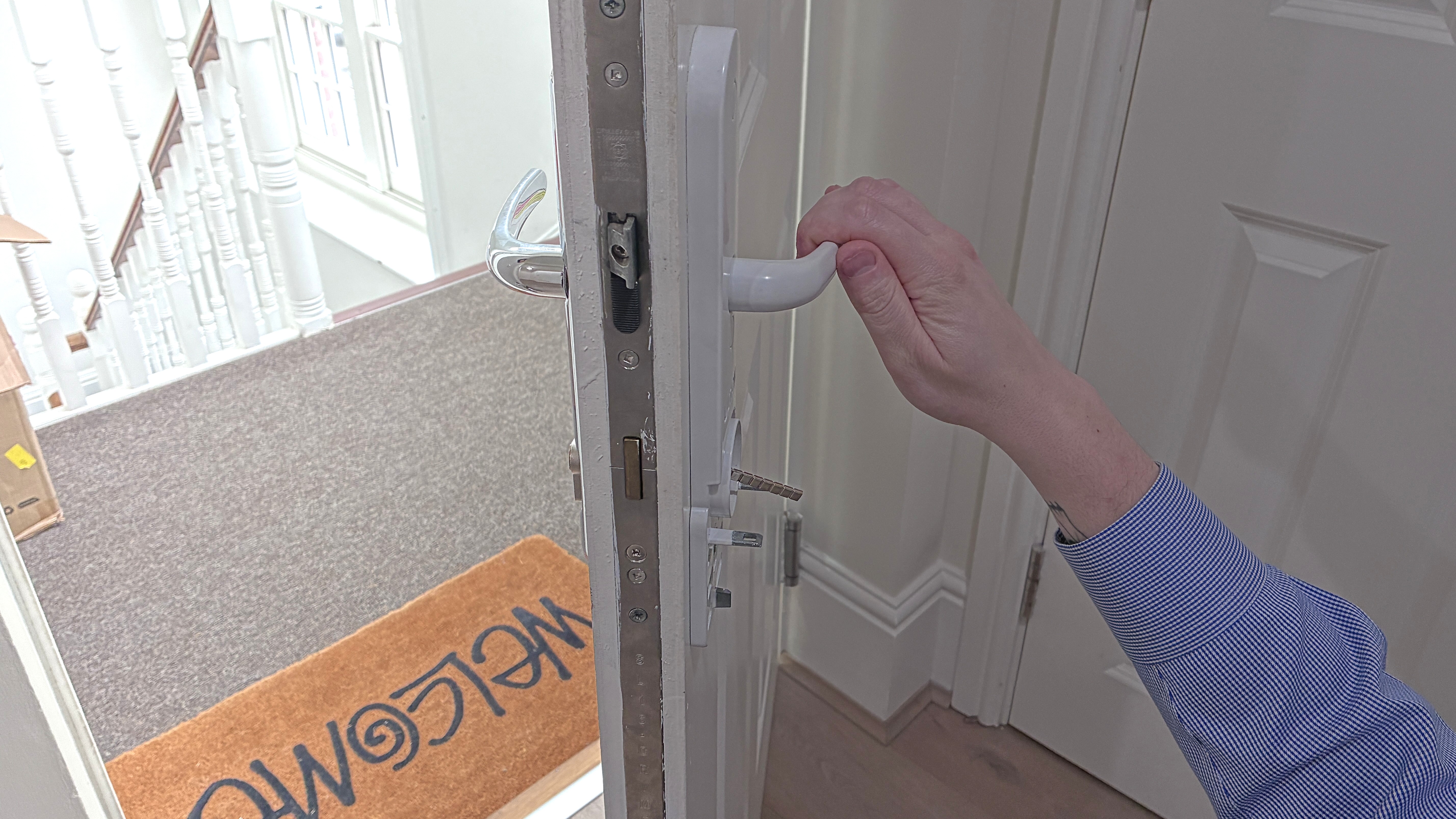 Person's hand setting up Ultion Nuki smart lock