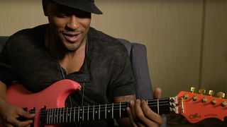 D'Angelo playing a pink G&L guitar