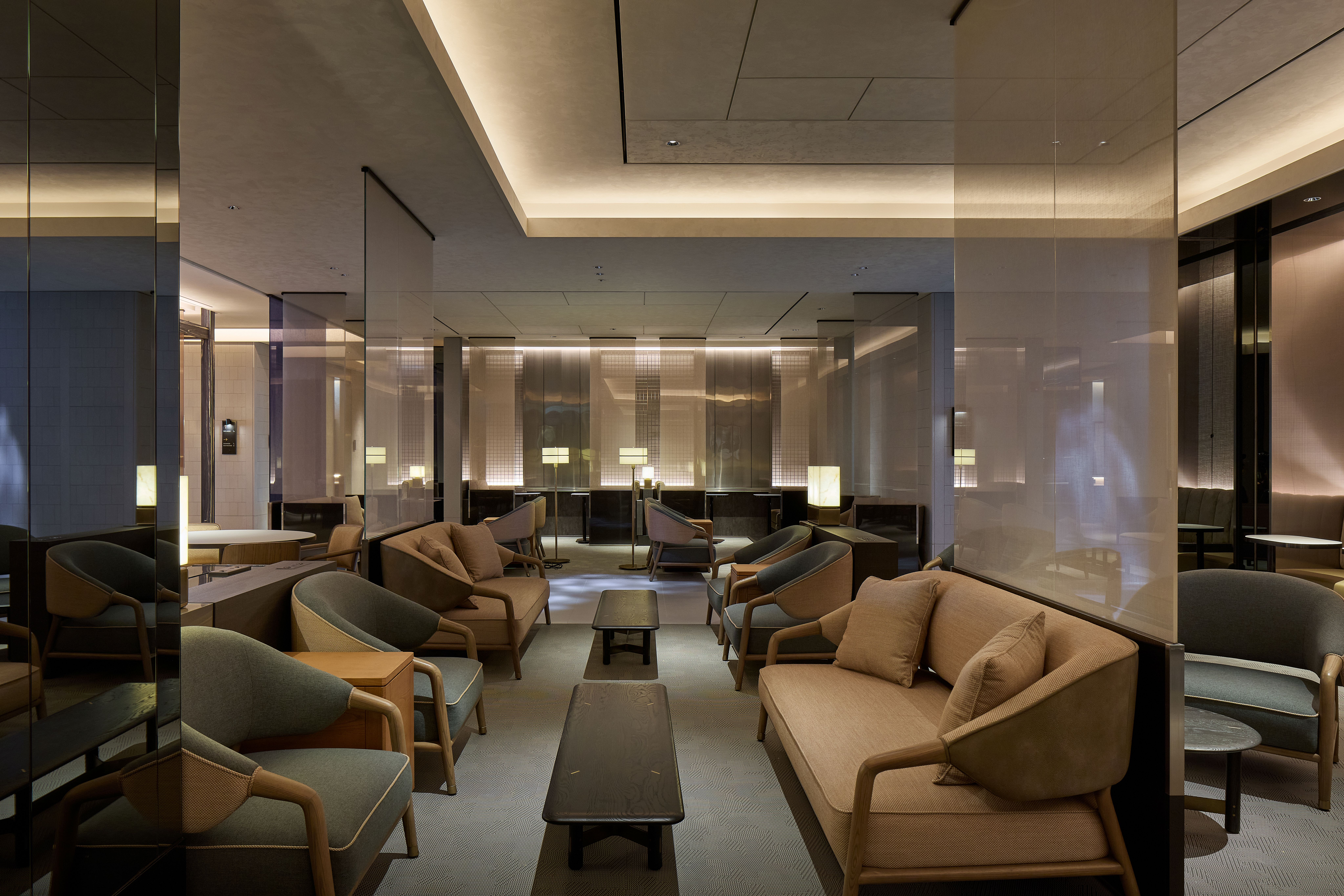 A spacious lounge interior at Incheon International Airport combines contemporary furnishings, natural textures and distinct areas for dining, work and relaxation