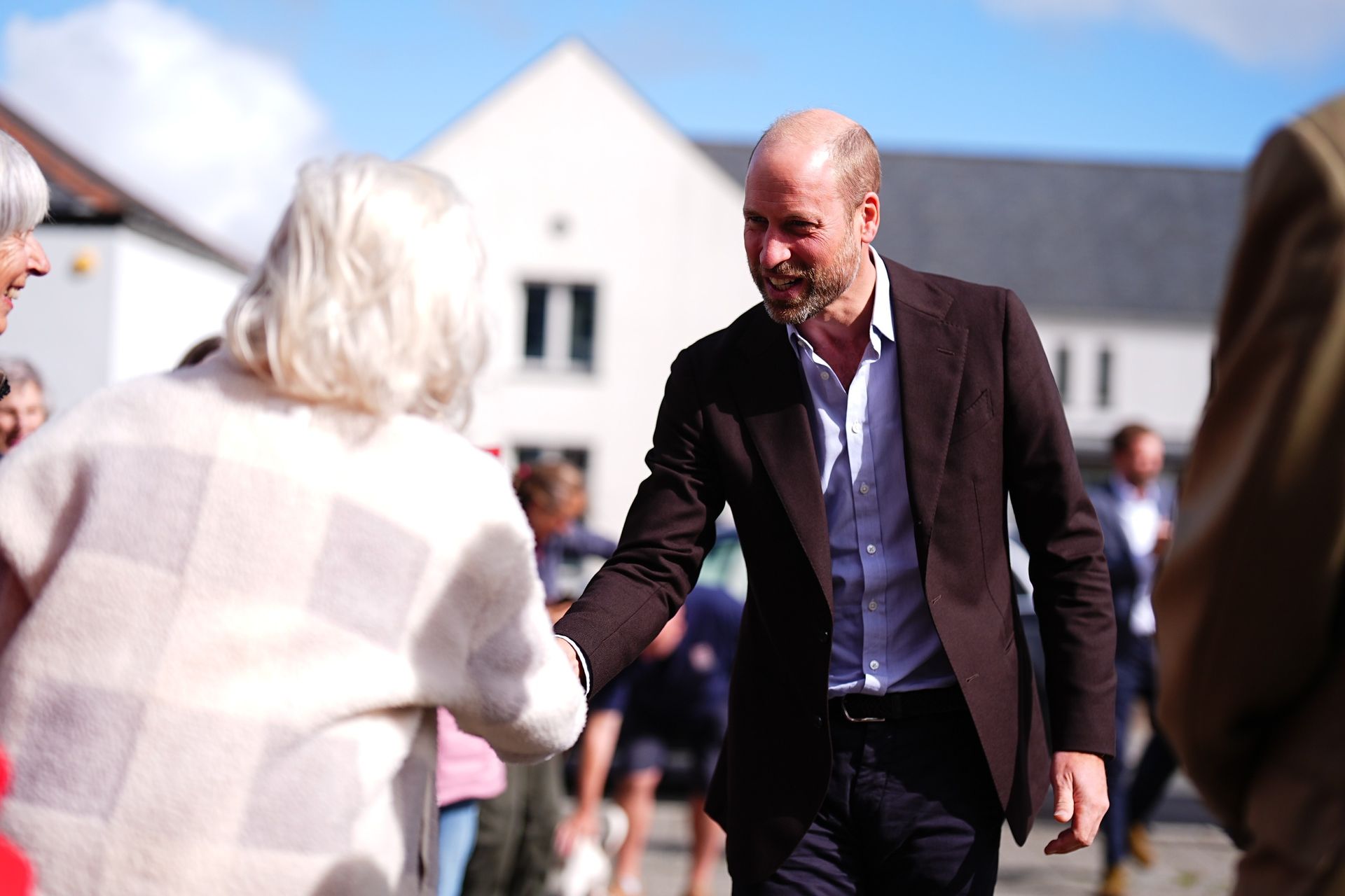 Prince William shaking hands with a woman