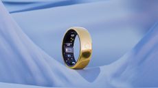 A press photo of the gold Circular Ring 2 on a photoshopped blue stage