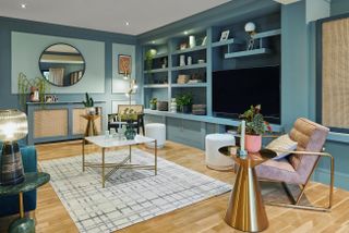 blue painted living room with open shelving and wooden floor