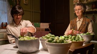 Miss Higgins and grandson Harry peeling sprouts