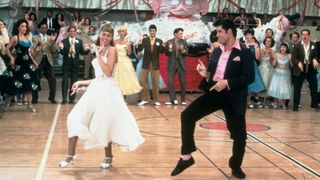 Olivia Newton John and John Travolta dance in Grease