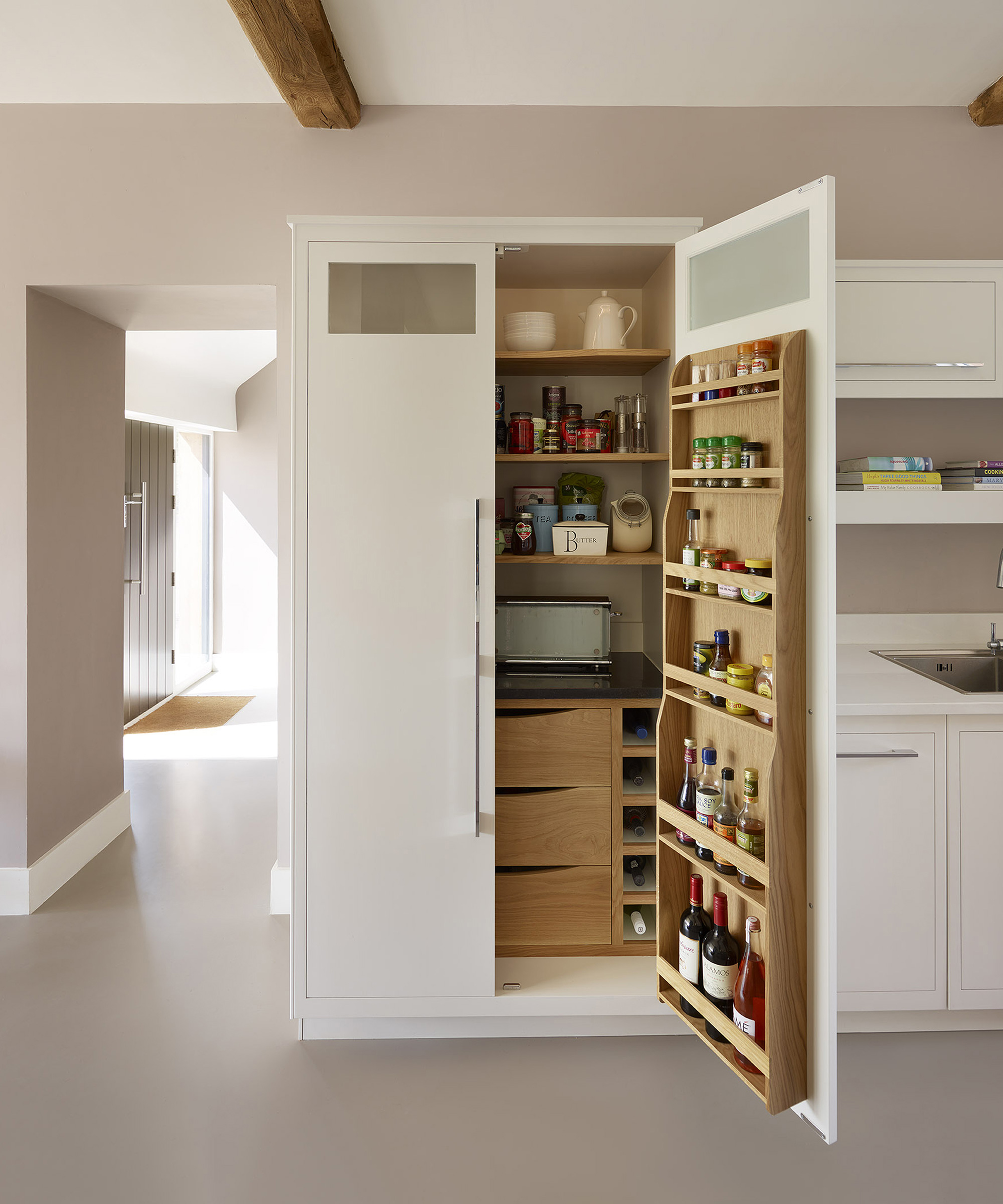 Kitchen trends 2021 showing a pantry concealed behind white floor to ceiling cabinets