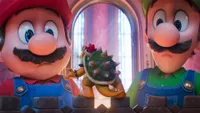 Mario and Luigi look at a tiny Bowser