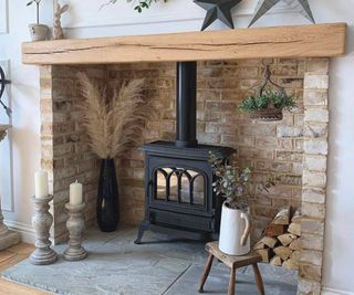 brick inglenook with oak beam and log burning stove