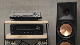 Onkyo TX-8470 next to a speaker 