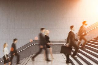 Commuters walking up stairs