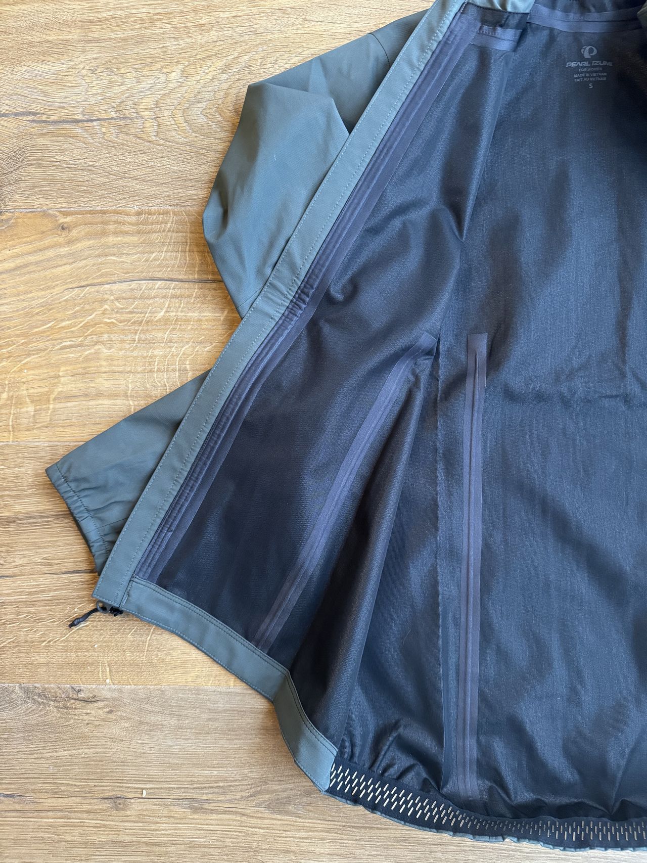 Flay lay jacket showing the taped seams and the inner black polyester