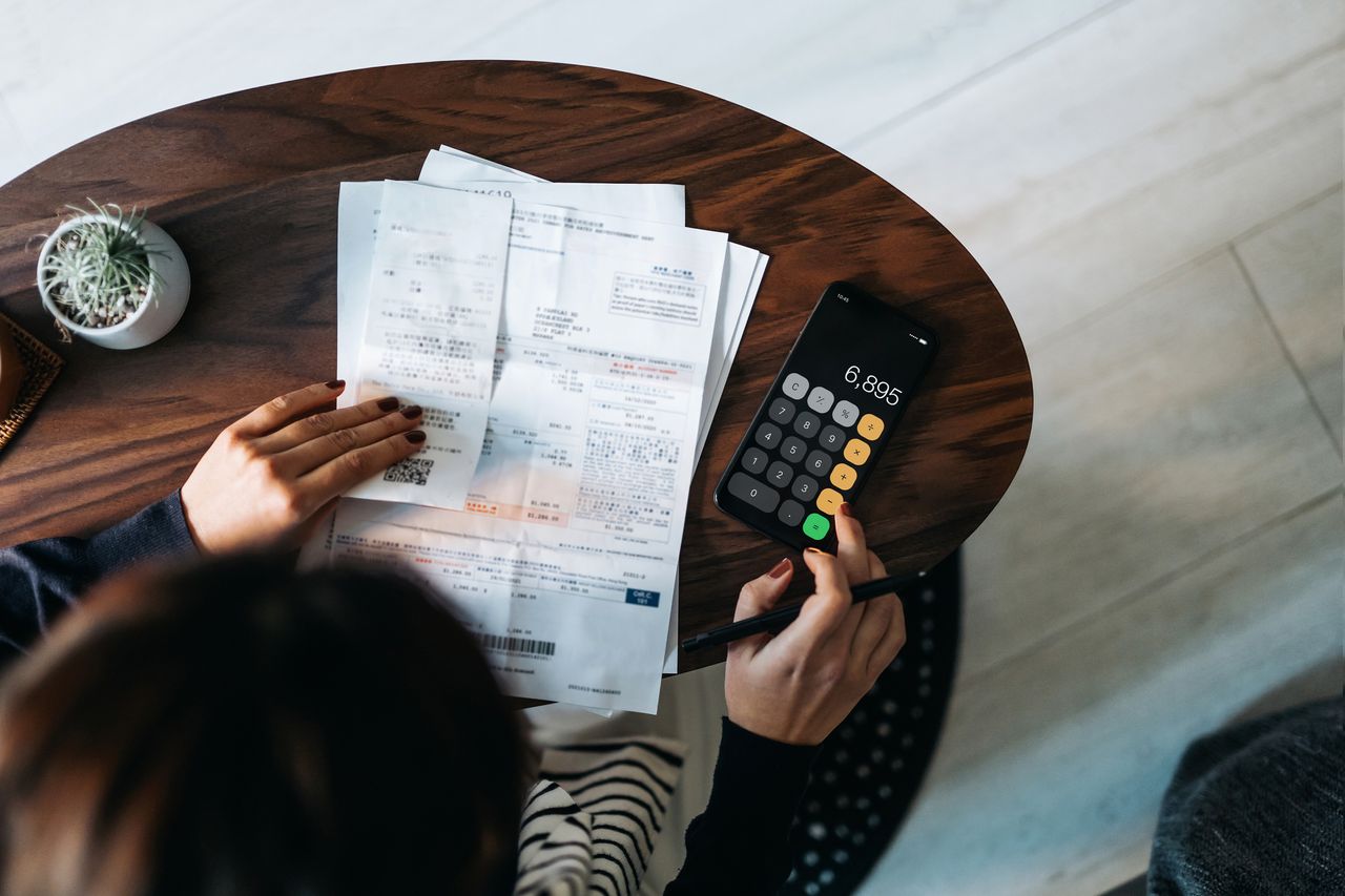 Overhead view of woman managing taxes and financial bills