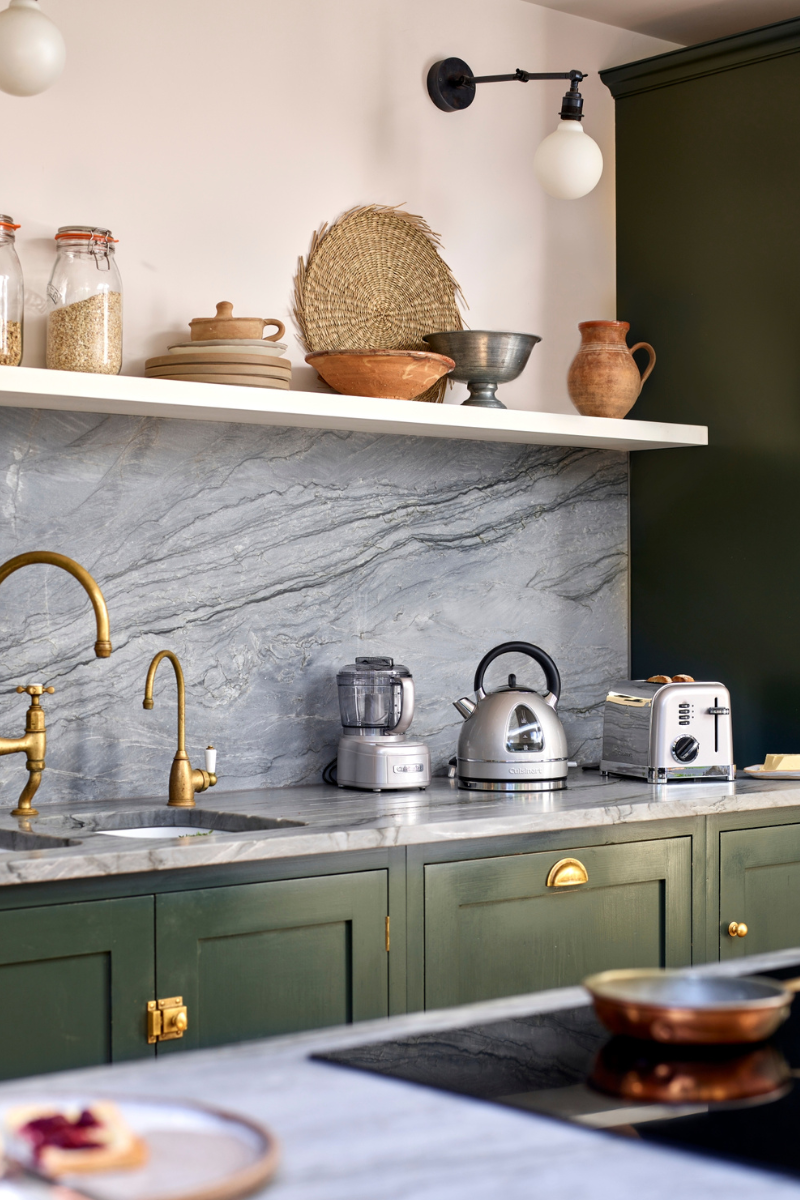 green kitchen with open shelving and appliances on countertop