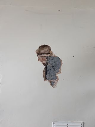 Another picture of the hole in the wall with an old man shape