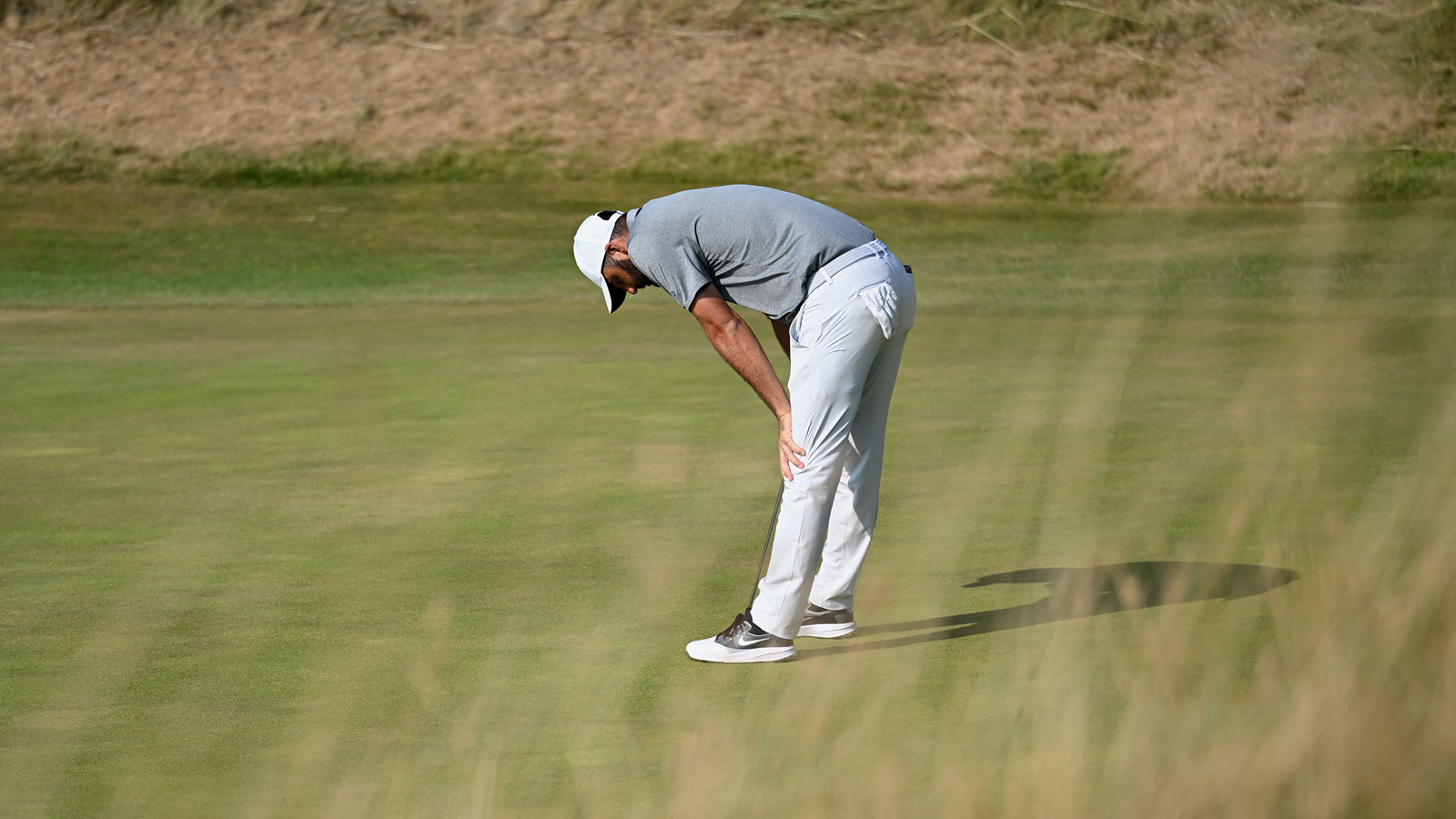 Scottie Scheffler reacts to a missed putt