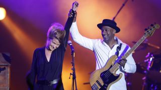 US Marcus Miller, jazz composer and bass guitarist, and Belgium singer Selah Sue (L) perform on stage during the Monte Carlo Summer Festival on July 23, 2014 in Monaco. AFP PHOTO / VALERY HACHE