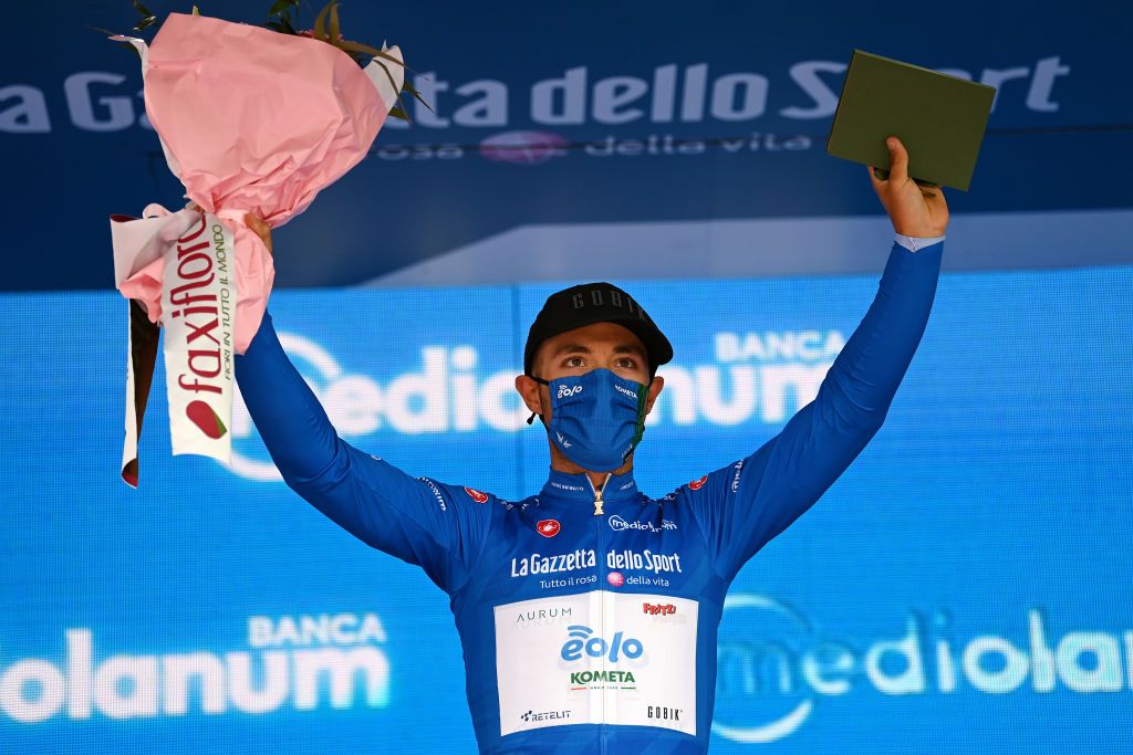 CANALE ITALY MAY 10 Vincenzo Albanese of Italy and EOLOKOMETA Cycling Team blue mountain jersey celebrates at podium during the 104th Giro dItalia 2021 Stage 3 a 190km stage from Biella to Canale Mask Covid safety measures Trophy Hostess girodiitalia Giro on May 10 2021 in Canale Italy Photo by Stuart FranklinGetty Images