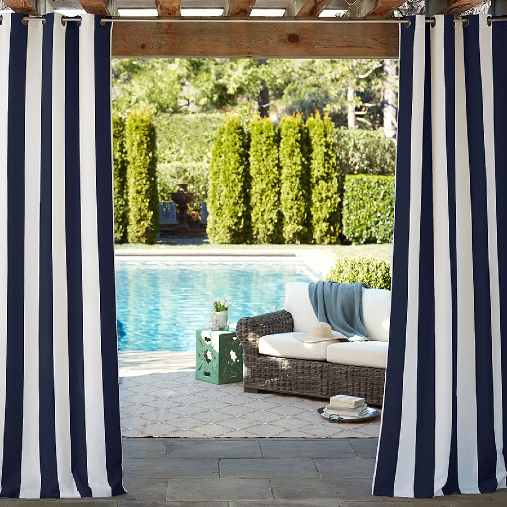 Poolside patio with striped curtains