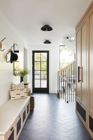 a modern entryway with a mudroom