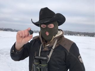 Meteorite-hunter Robert Ward poses with one of the meteorites found on Jan. 18, 2018, two days after a meteor caused a spectacular fireball in the Michigan night sky.