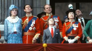 Various members of the royal family stood on the balcony of Buckingham Palace, Diana is in a blue co-ord with matching hat, the rest are in their military dress