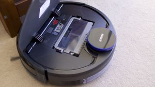 The Deebot Ozmo 930 has it's own cleaning tool nestled in front of the bin