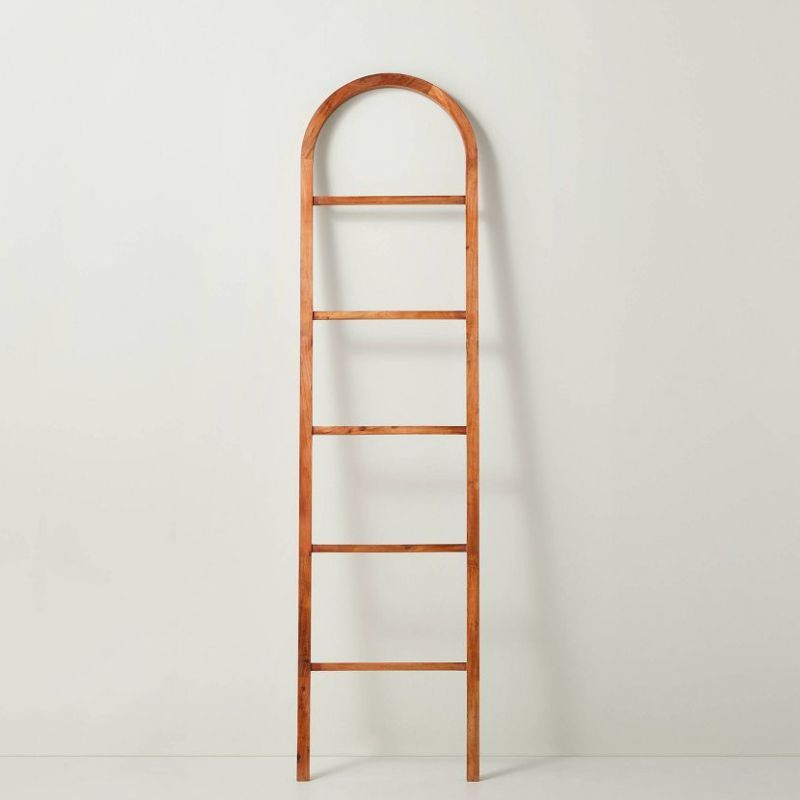 A brown wooden arched throw blanket ladder is one of the best Target furniture pieces.