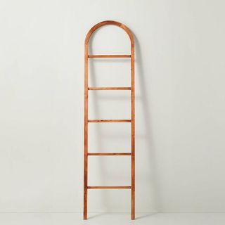 A brown wooden arched throw blanket ladder is one of the best Target furniture pieces.