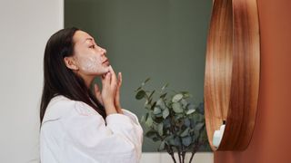 woman applying face cream