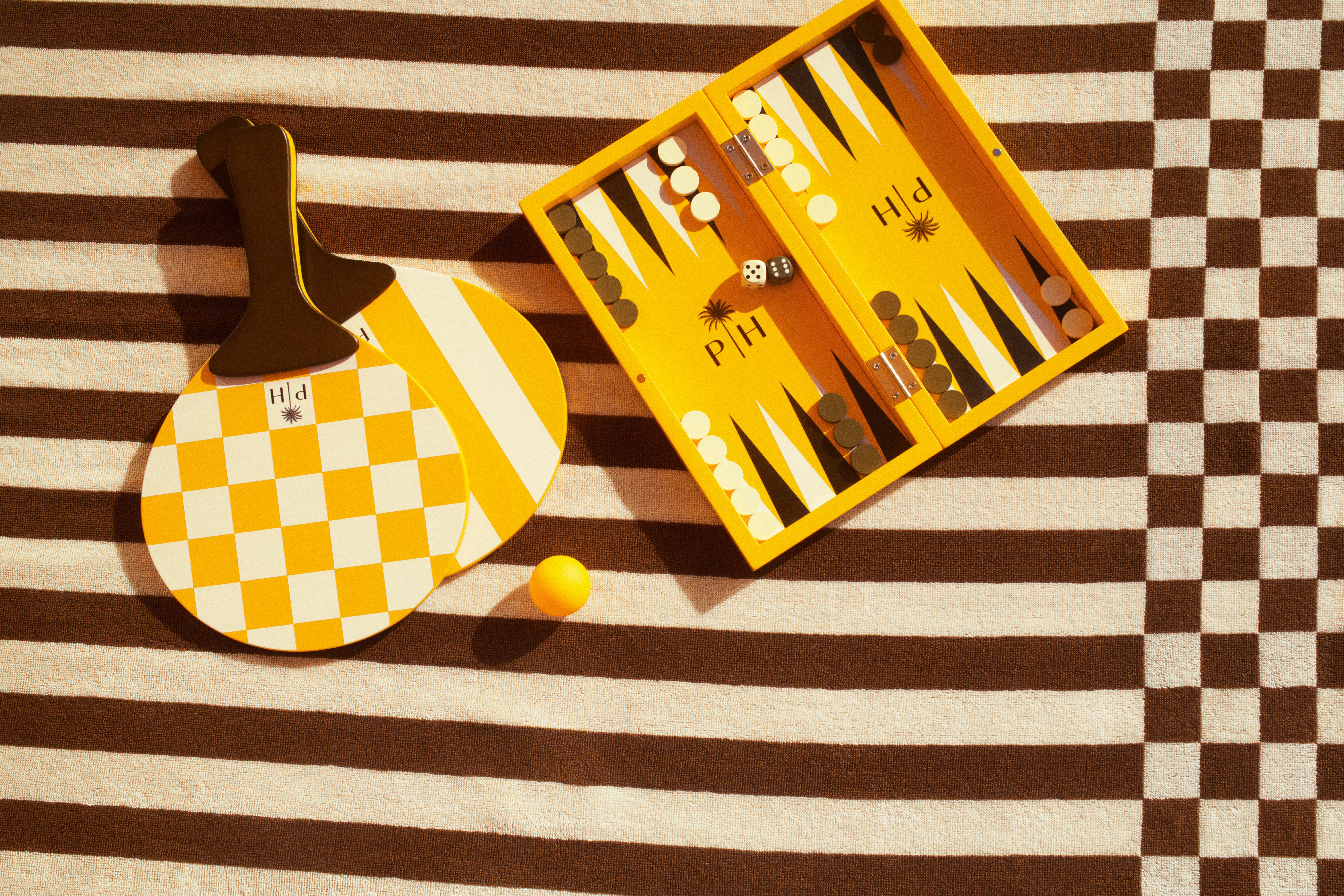 A resort-inspired home and loungewear collection features bright tones of yellow inspired by summer's warmth, wooden notes, and a stripy essence.