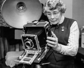 Royal photographer Lisa Sheridan checks her camera in her studio, 1960. (Photo by Rosemary Matthews/Keystone Features/Hulton Archive/Getty Images)