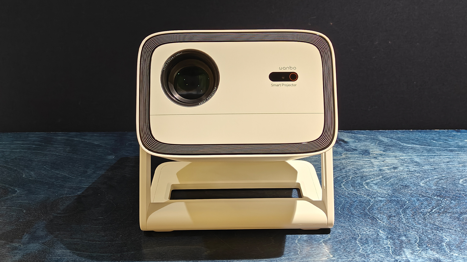 Wanbo Vali 1 home cinema projector on black wooden surface