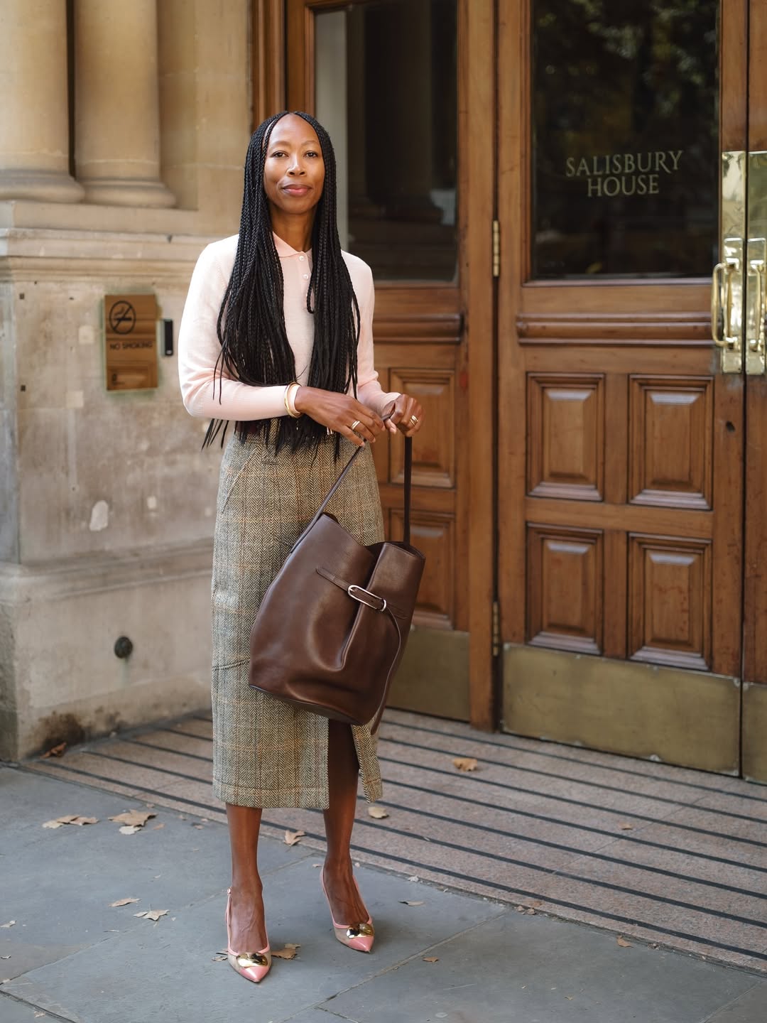 @thandimaq wears skirt, polo and work bag