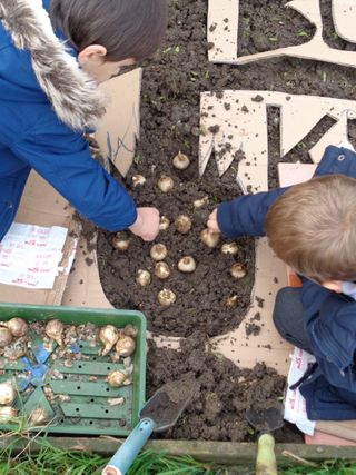 children planting spring bulbs