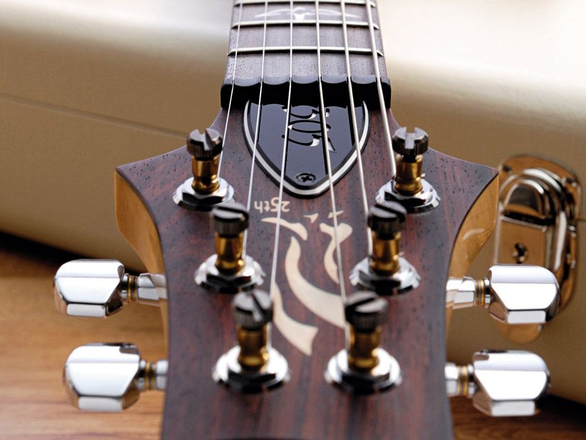 The rosewood-faced peghead has the 25th anniversary logo for this year only.