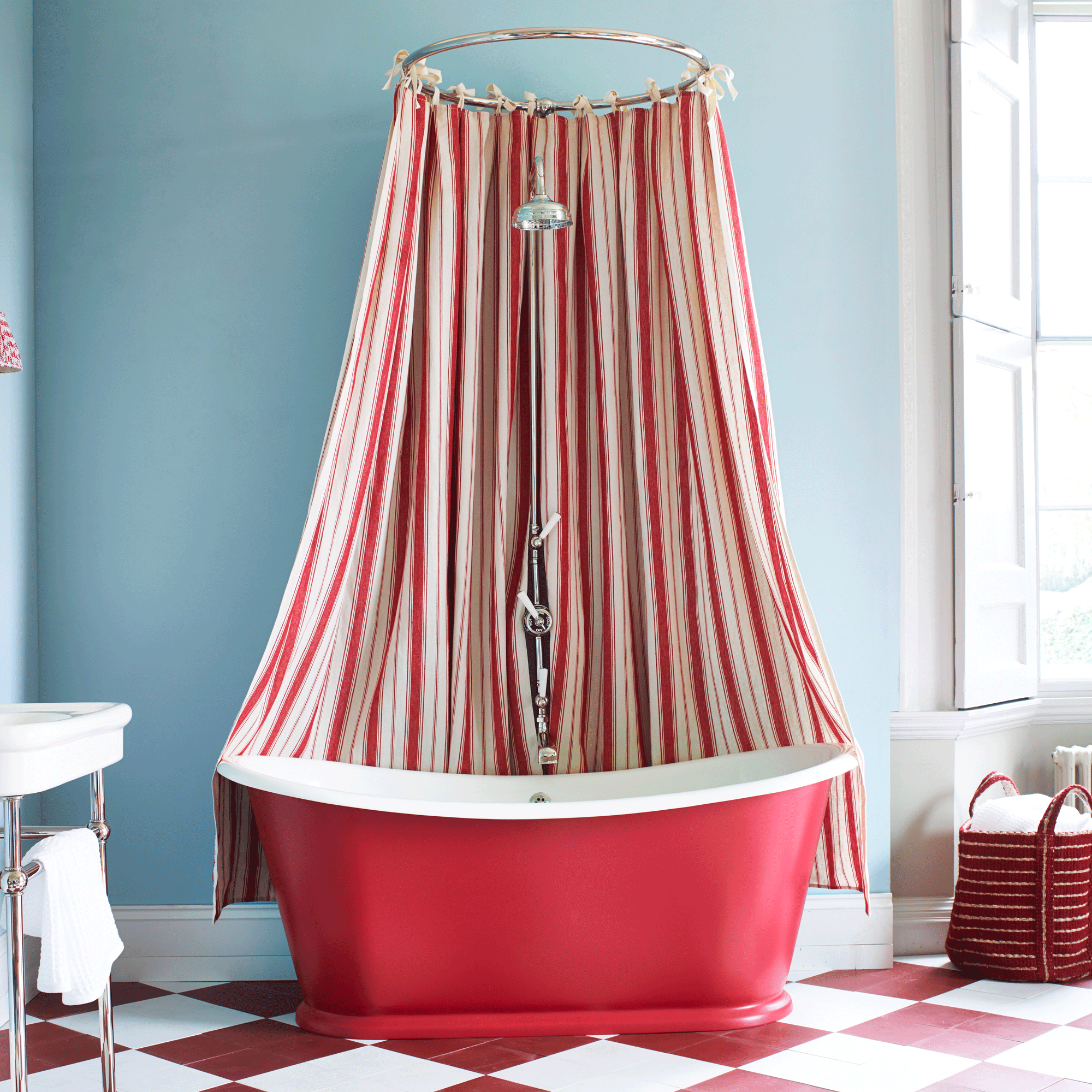 Red and white stripey shower curtain over red bath