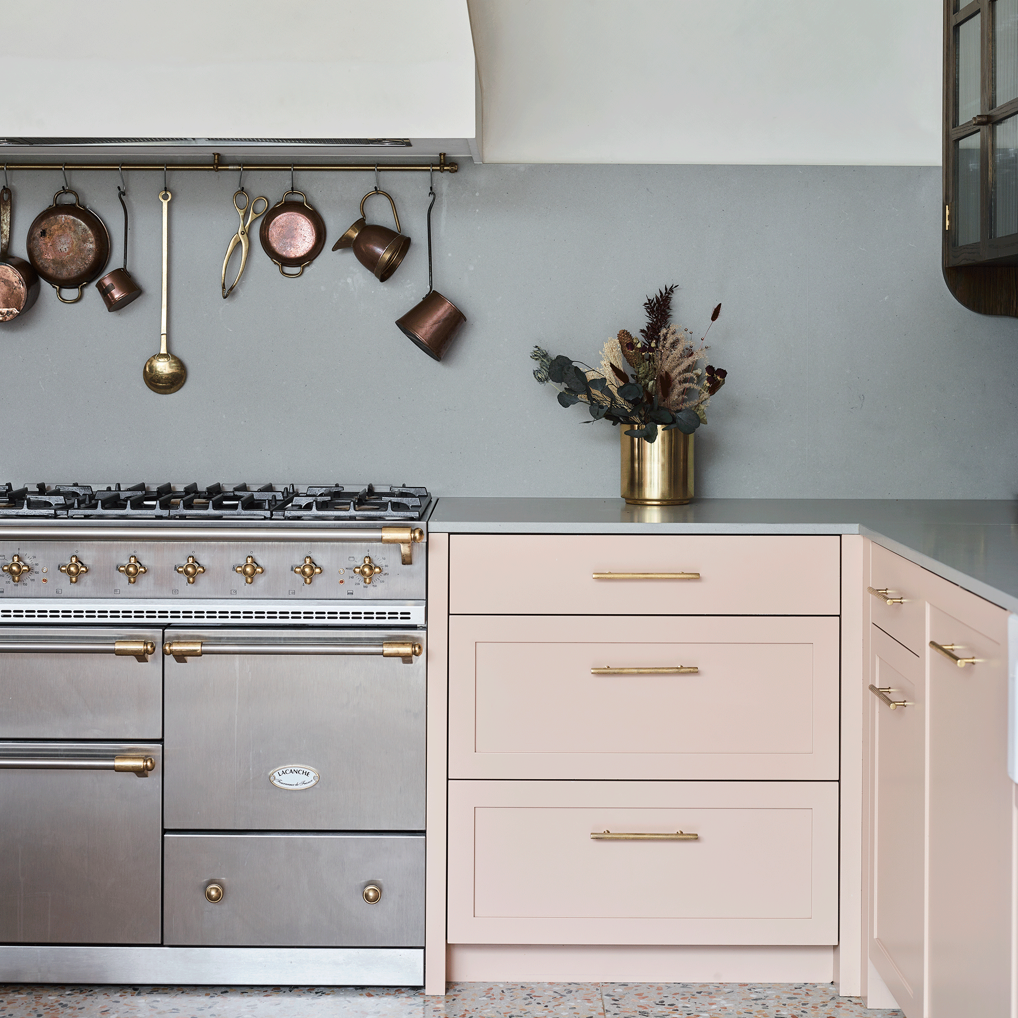 Pink kitchen cupboards with gold handles