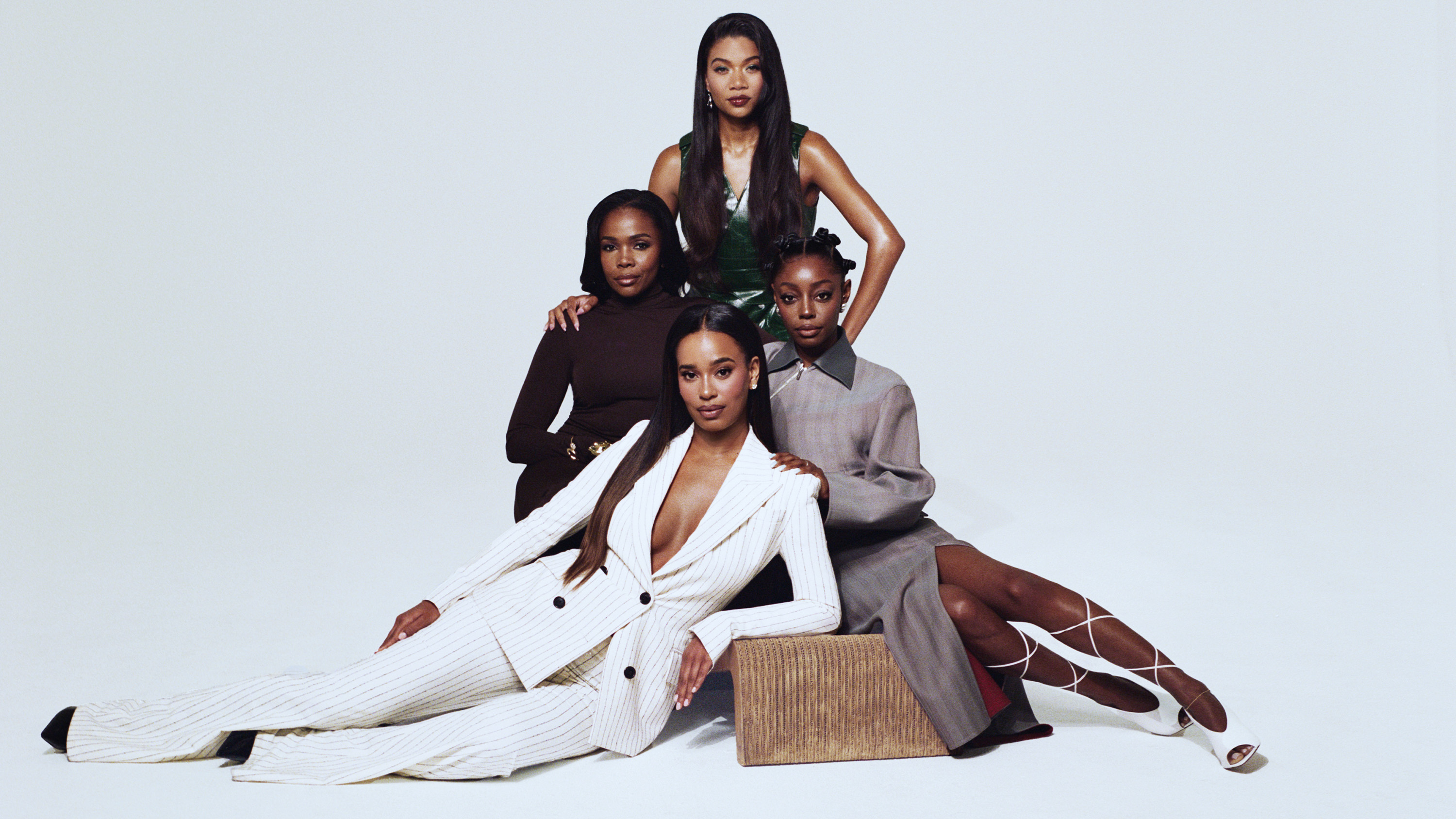 Lake Rucker, Jasmine Goode, Venita Aspen, and Mia Calabrese pose together against a white backdrop and look into the camera